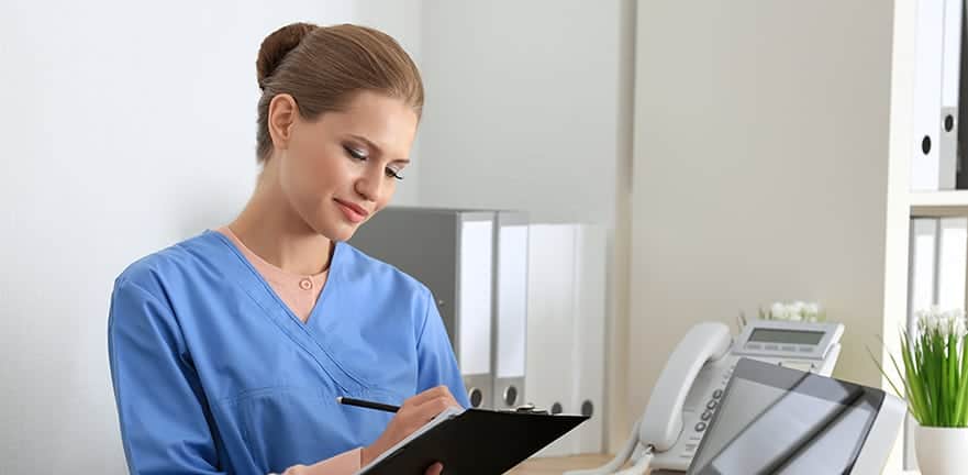 Young female receptionist holding folder with documents in hospi